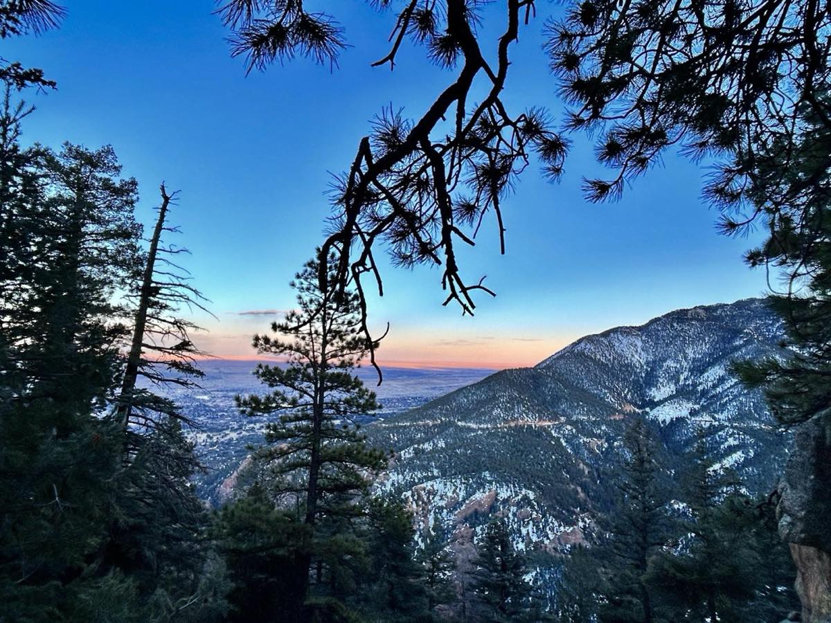 Golden mountain ridge at sunset, with light spilling over the horizon.